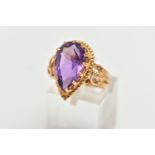 AN 18CT GOLD AMETHYST RING, designed with a pear cut amethyst, in a thirteen claw setting, measuring