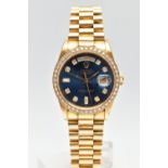 AN 18CT YELLOW GOLD AND DIAMOND DAY-DATE ROLEX WRISTWATCH, the dark blue dial with diamond dot