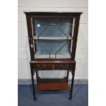 A LIBERTY OF LONDON EDWARDIAN MAHOGANY DISPLAY CABINET, the single astragal glazed door enclosing