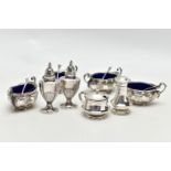 A PARCEL OF LATE VICTORIAN AND 20TH CENTURY SILVER CRUET ITEMS, comprising a set of four late