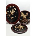 A PAIR OF EARLY 20TH CENTURY SHIBAYAMA CIRCULAR PANELS AND ANOTHER SIMILAR OVAL, all three depicting