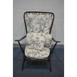 A DARK ERCOL WINDSOR ARMCHAIR, with floral cushions (condition:- this chair does not comply with the