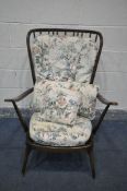 A DARK ERCOL WINDSOR ARMCHAIR, with floral cushions (condition:- this chair does not comply with the