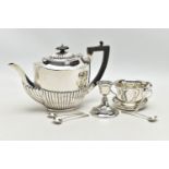 A GEORGE V SILVER TEA POT OF OVAL FORM, domed cover with reeded detail, ebonised fitments, the lower