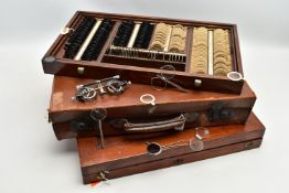 AN EARLY 20TH CENTURY MAHOGANY CASED OPTOMETRIST SET, the interior fitted with a selection of lenses