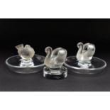 TWO LALIQUE RING / PIN TRAYS AND A LALIQUE PAPERWEIGHT, the two clear glass ring trays with a