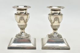 A PAIR OF LATE VICTORIAN SILVER DWARF CANDLESTICKS, beaded rims throughout, the urn shaped