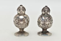 A PAIR OF GEORGE V SILVER NOVELTY SALT AND PEPPER POTS IN THE FORM OF 'LITTLE TOM TUCKER', the