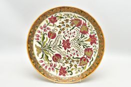 A ZSOLNAY PECS POTTERY POLYCHROME ENAMELLED CHARGER, ochre rim surrounding a rough textured gilt and