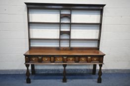 A GEORGE III OAK DRESSER, the top with an arrangement of shelving, and a single drawer, over a