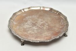 A GEORGE V SILVER SALVER, with gadrooned Chippendale pie crust edge, plain centre, on four short