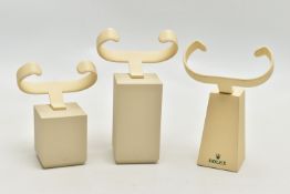 A SELECTION OF THREE ROLEX WATCH DISPLAY STANDS, of various sizes, to include two cream gents stands