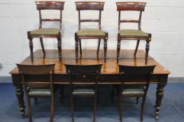 A REGENCY FLAME MAHOGANY DINING TABLE, on eight turned legs with large brass caps and casters,