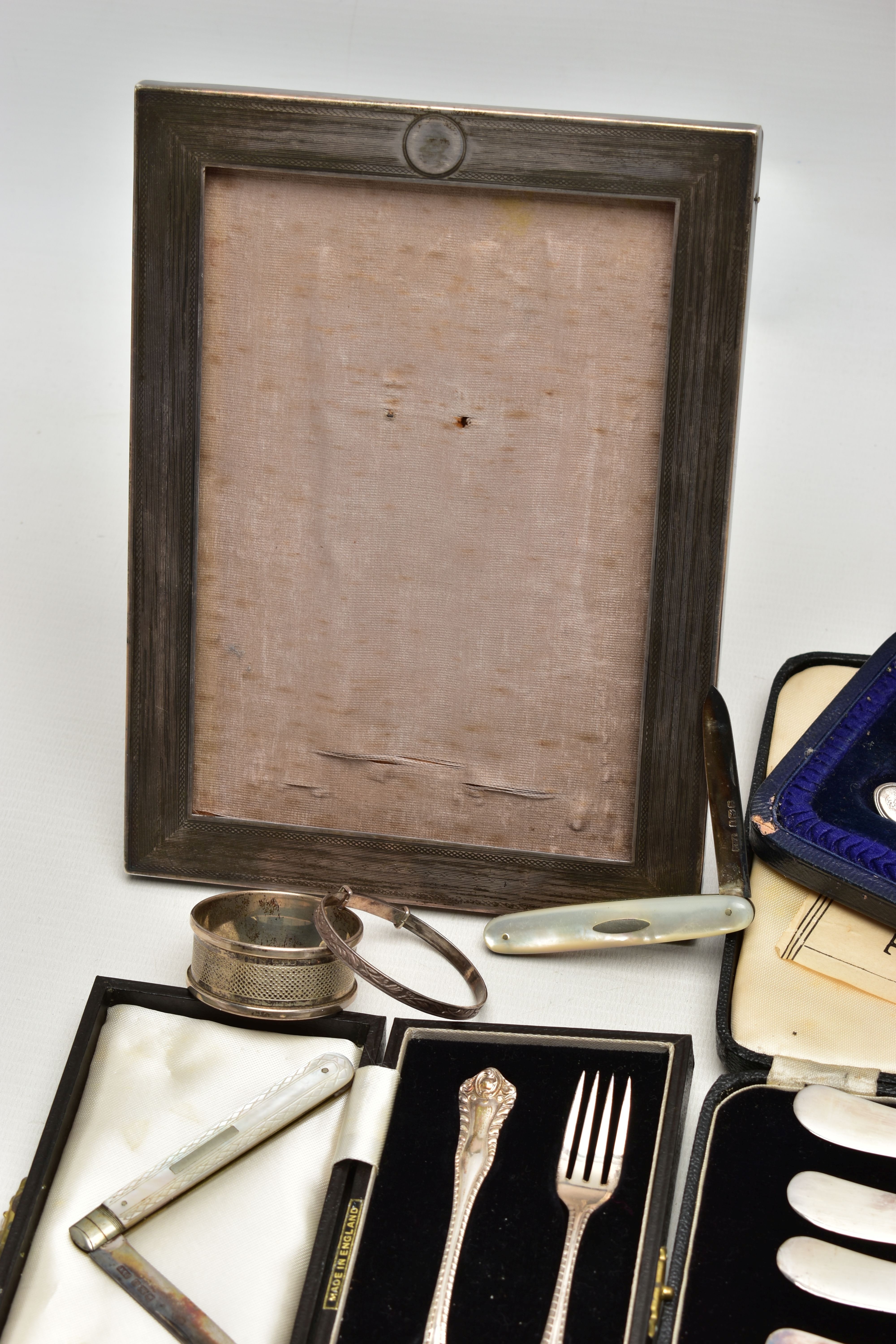 A GROUP OF CASED AND LOOSE SILVER, comprising a rectangular photograph frame, engine turned - Image 2 of 9