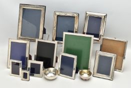TWELVE SILVER PHOTOGRAPH FRAMES AND TWO SMALL SILVER PLATED BOWLS, all of the photograph frames