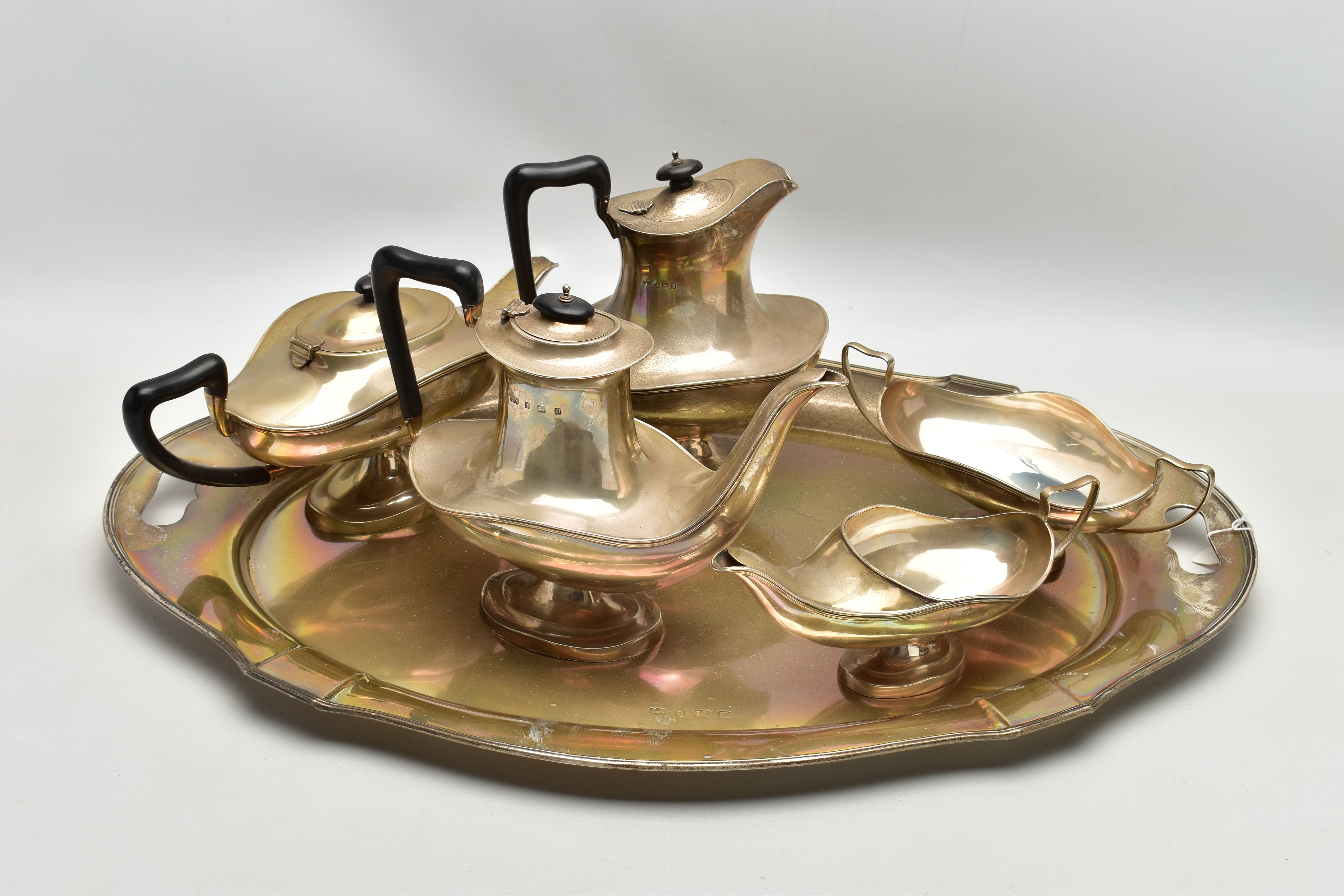 A GEORGE V SILVER FIVE PIECE TEA SET ON OVAL TWIN HANDLED TRAY, the set of oval / Aladdin's lamp