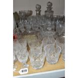 A GROUP OF CUT GLASS DRINKING GLASSES, DECANTERS AND BOWLS ETC, to include matched sets of six