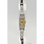 A LADIES 1920S PLATINUM AND DIAMOND COCKTAIL WATCH, manual wind, rectangular dial, worn Arabic