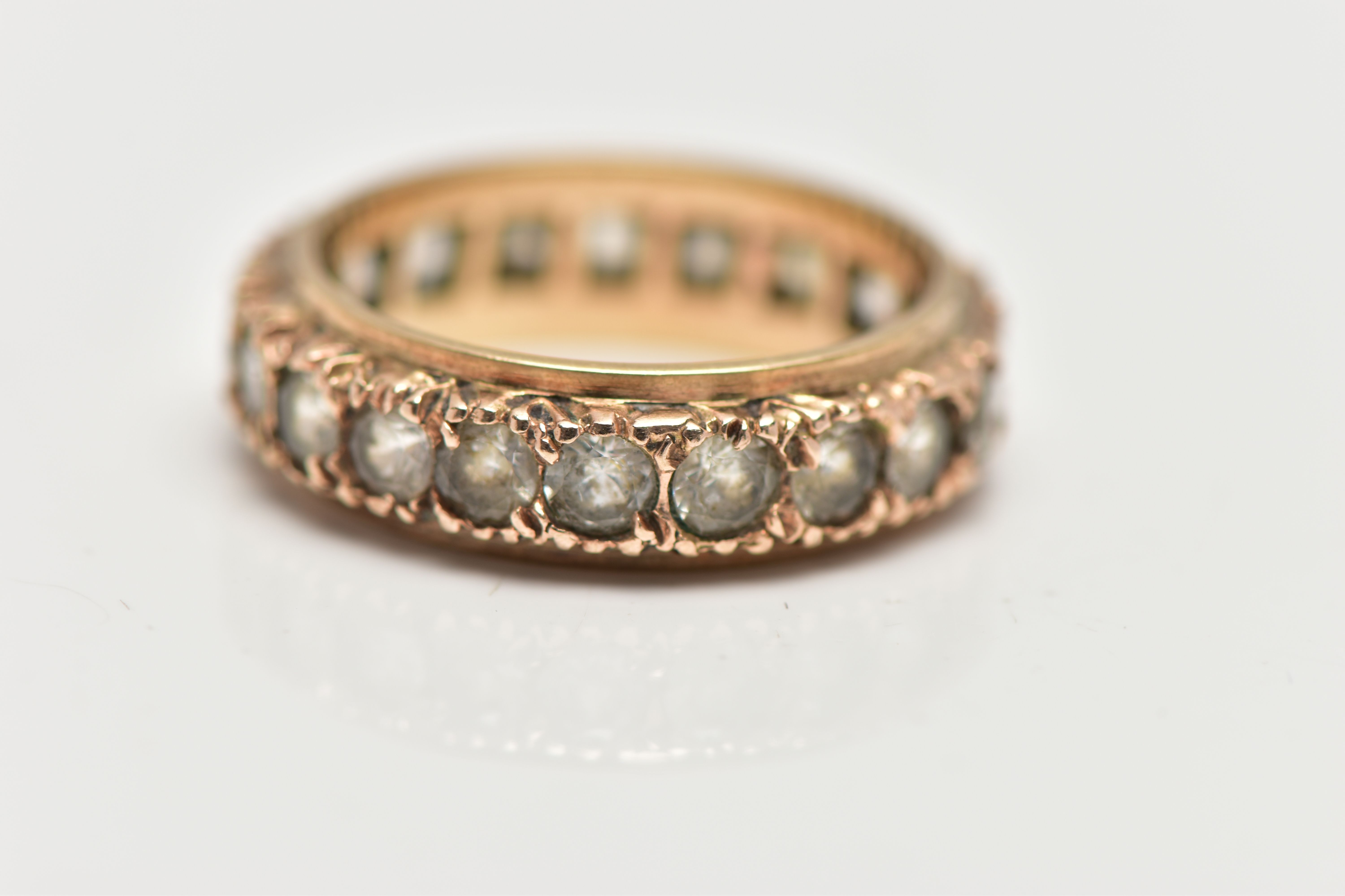 A YELLOW METAL FULL ETERNITY RING, set with a row of circular cut colourless stones assessed as - Image 4 of 4