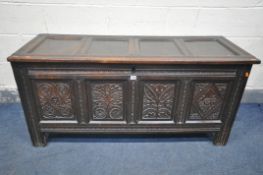 A GEORGIAN CARVED OAK PANELLED COFFER, length 141cm x depth 53cm x height 66cm (condition:-