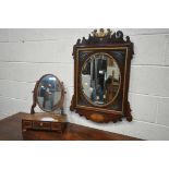 AN EARLY 19TH CENTURY MAHOGANY AND GILT FRETWORK FRAMED WALL MIRROR, with an oval bevelled plate,