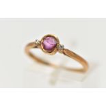 A YELLOW METAL RUBY AND DIAMOND RING, designed with a collet set ruby, flanked with two small