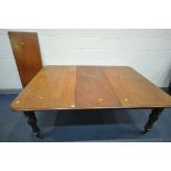 A VICTORIAN MAHOGANY EXTENDING DINING TABLE, with fluted legs on brass casters, along with two