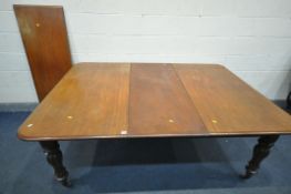A VICTORIAN MAHOGANY EXTENDING DINING TABLE, with fluted legs on brass casters, along with two