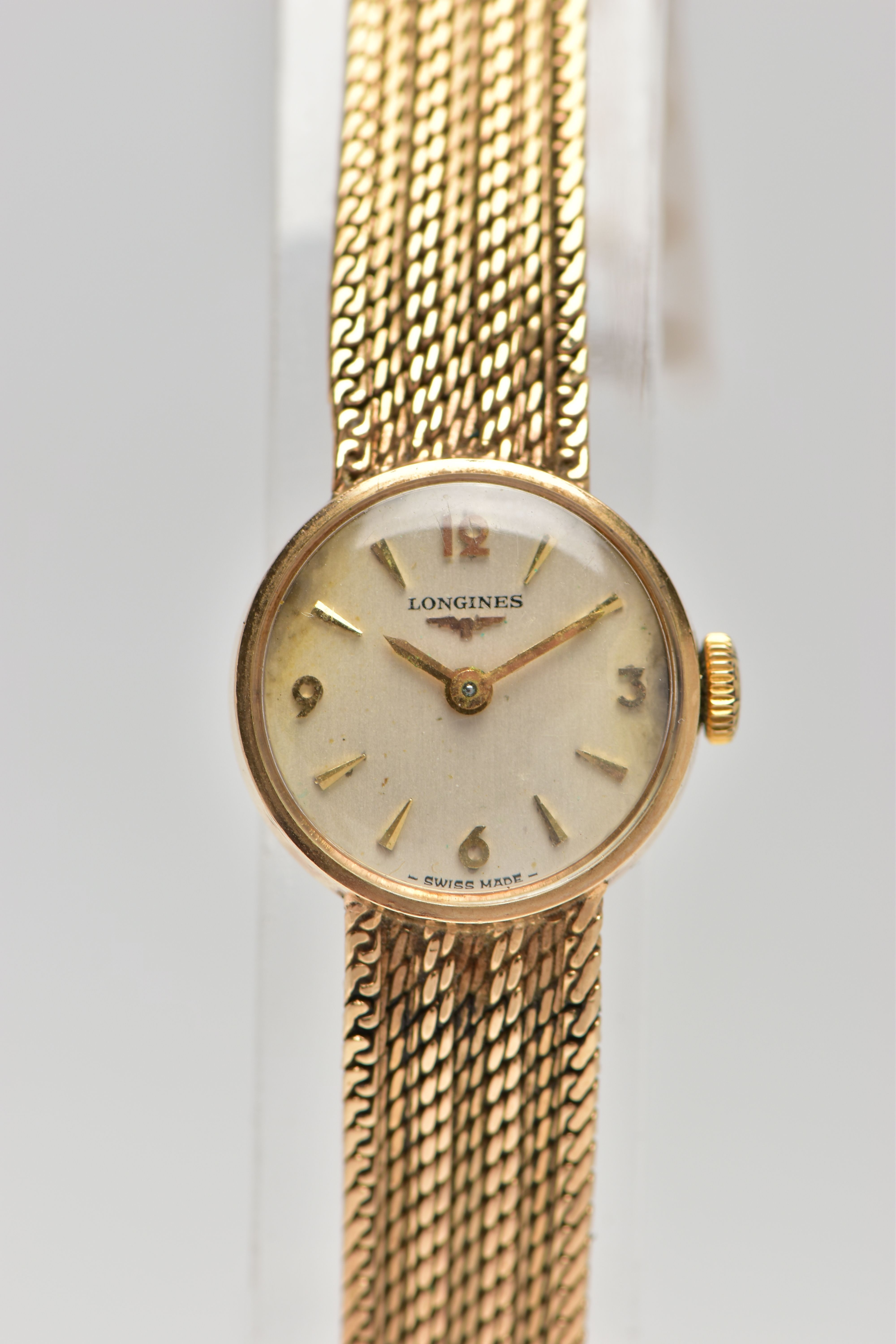 A LADIES 9CT GOLD 'LONGINES' WRISTWATCH, manual wind, round silver dial signed 'Longines', Arabic