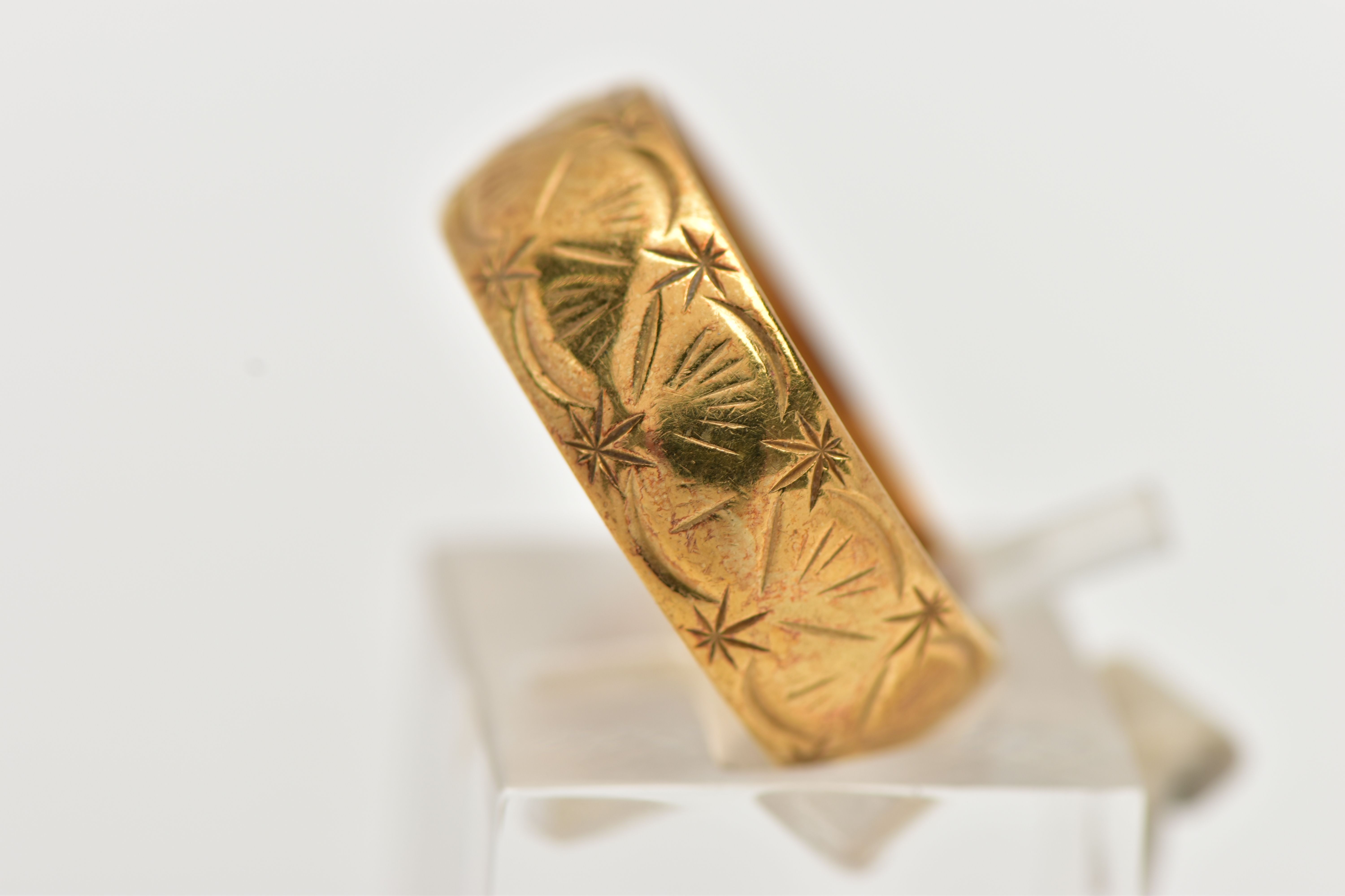 AN 18CT GOLD WIDE BAND RING, decorated with a diamond cut shell pattern, approximate band width 6. - Image 2 of 3