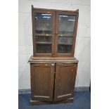 A VICTORIAN SCUMBLED PINE BOOKCASE, with double glazed doors above panelled cupboard doors, width