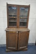 A VICTORIAN SCUMBLED PINE BOOKCASE, with double glazed doors above panelled cupboard doors, width