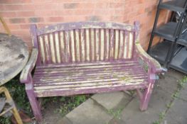 A WOODEN SLATTED GARDEN BENCH width 124cm (Condition distressed paint work but sturdy)