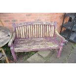 A WOODEN SLATTED GARDEN BENCH width 124cm (Condition distressed paint work but sturdy)