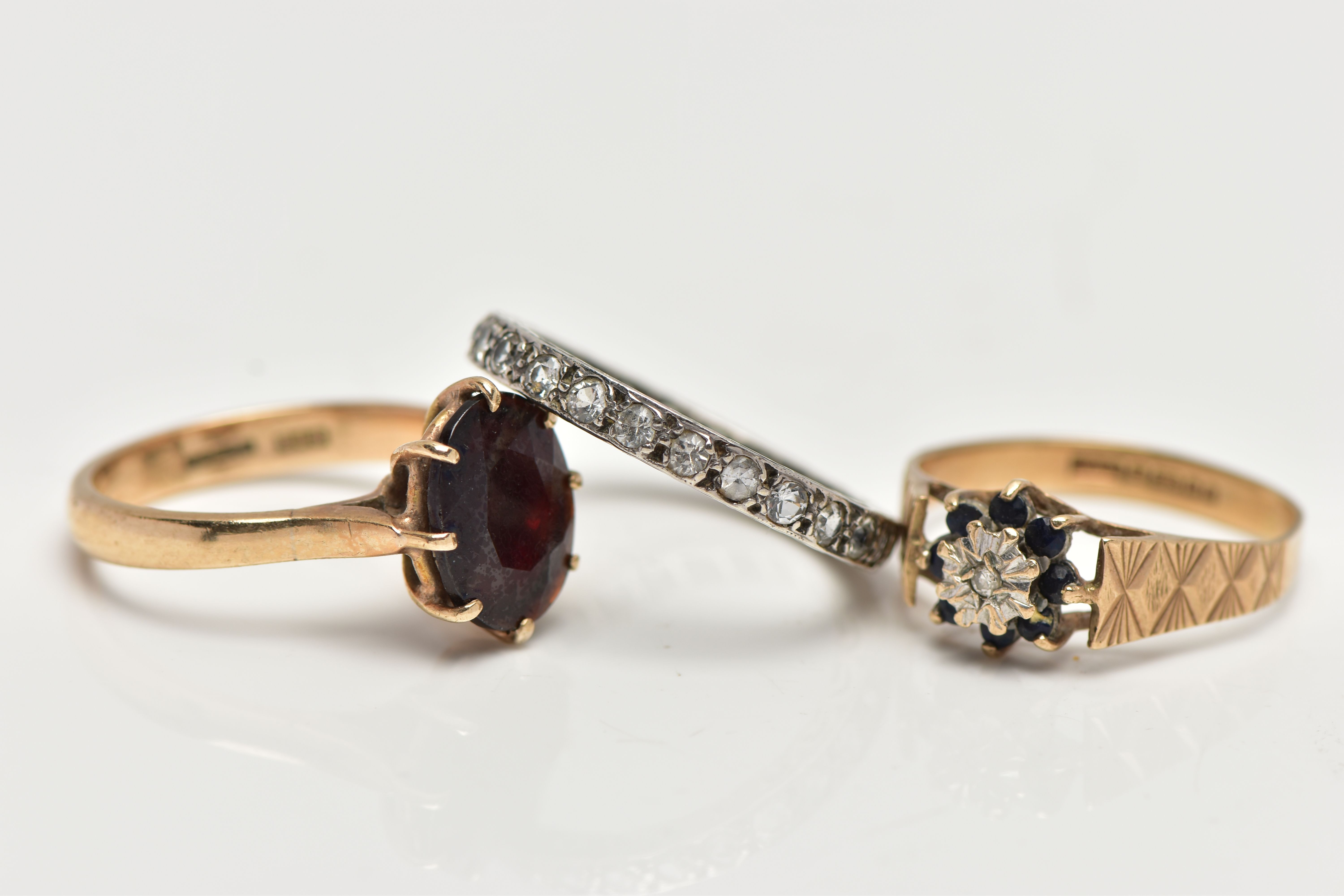 THREE GEM SET RINGS, the first designed with an oval cut garnet in an eight claw setting with - Image 2 of 4
