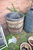 A PAIR OF OAK HALF BARREL PLANTERS 63cm in diameter with poly liners for both