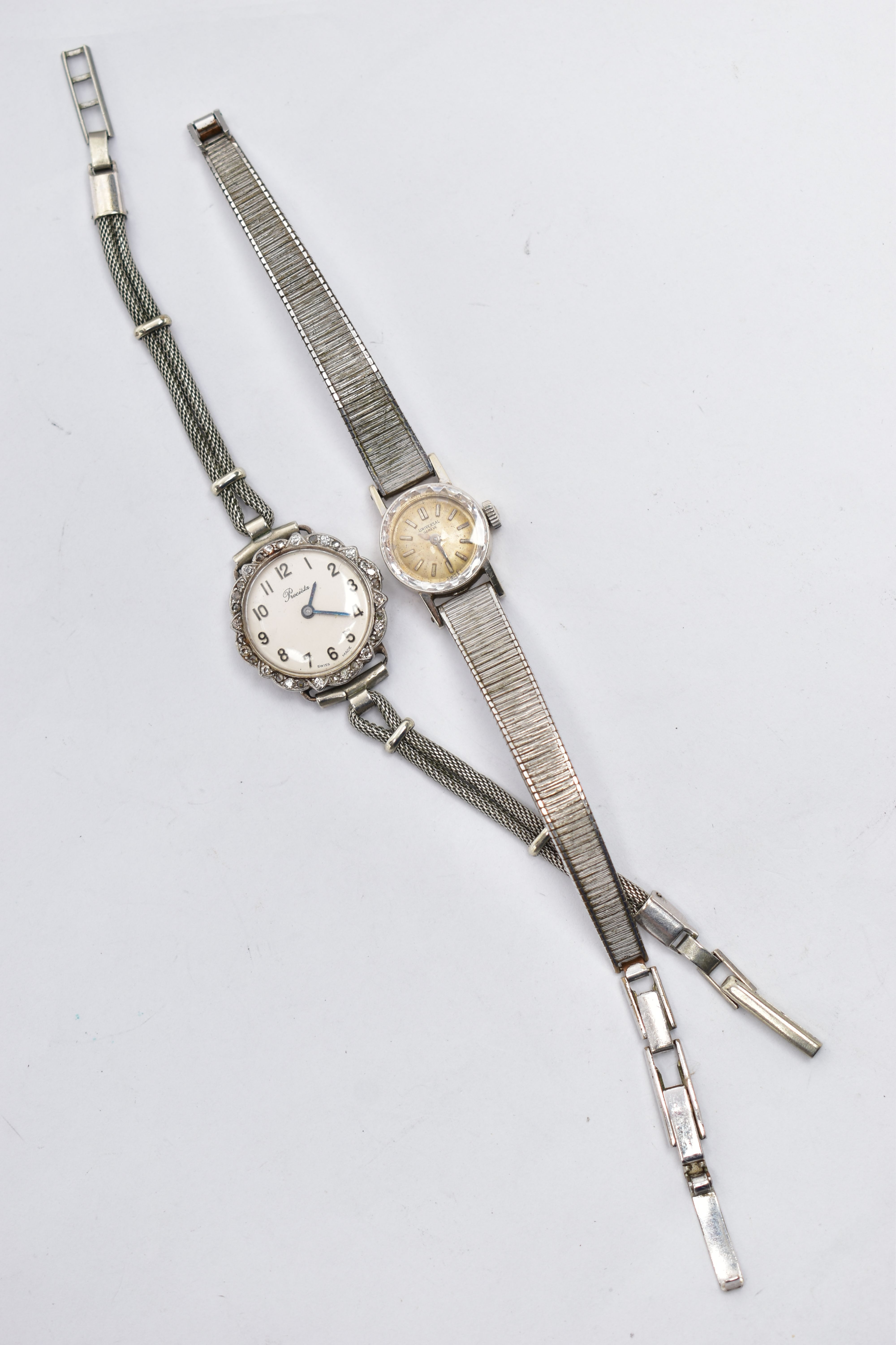 TWO LADIES WRISTWATCHES, the first a white metal 'Precista' watch, missing crown, round silver