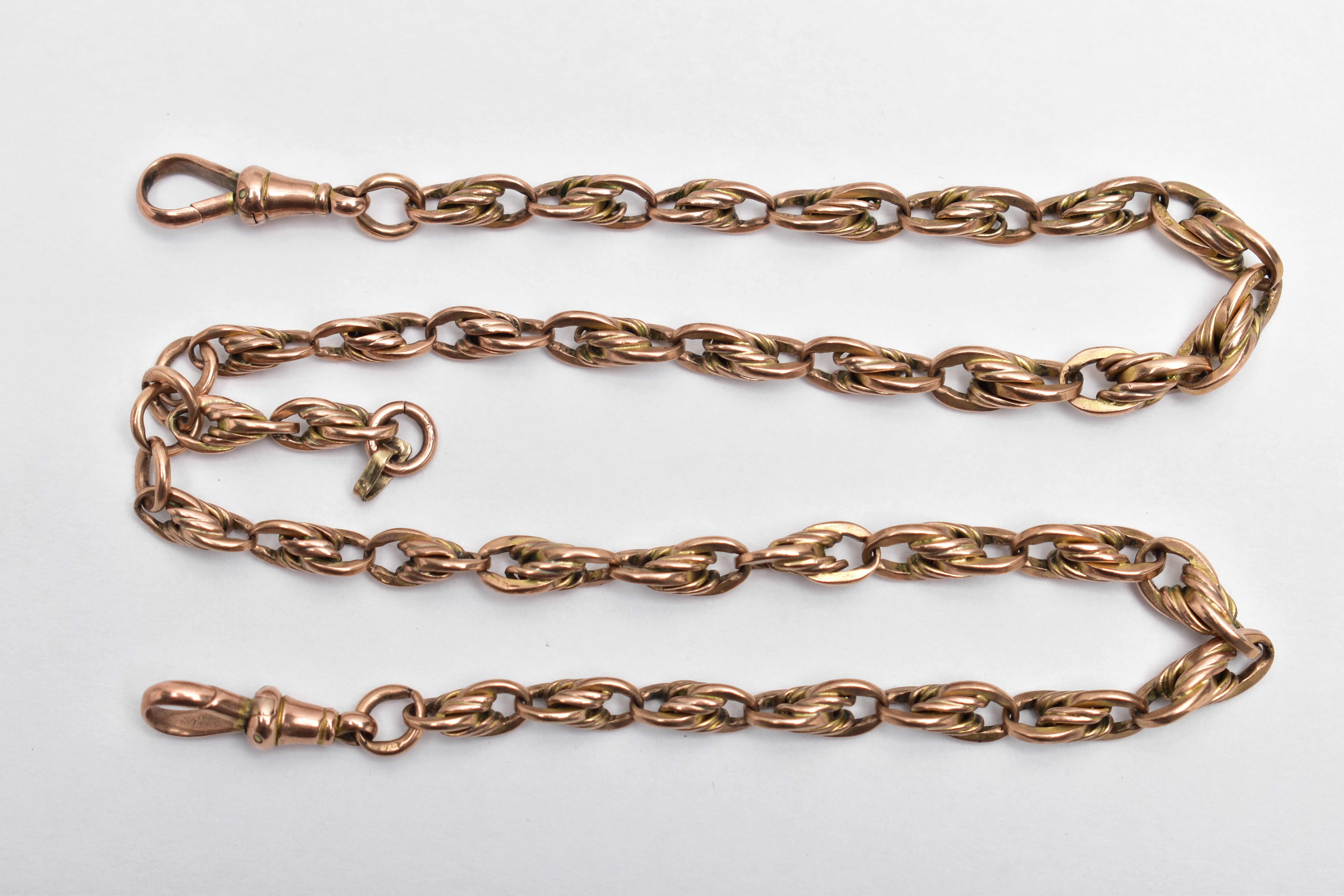 A ROSE TONE ALBERT CHAIN, of a rope twist and oval link design, most links stamped 9.375, fitted