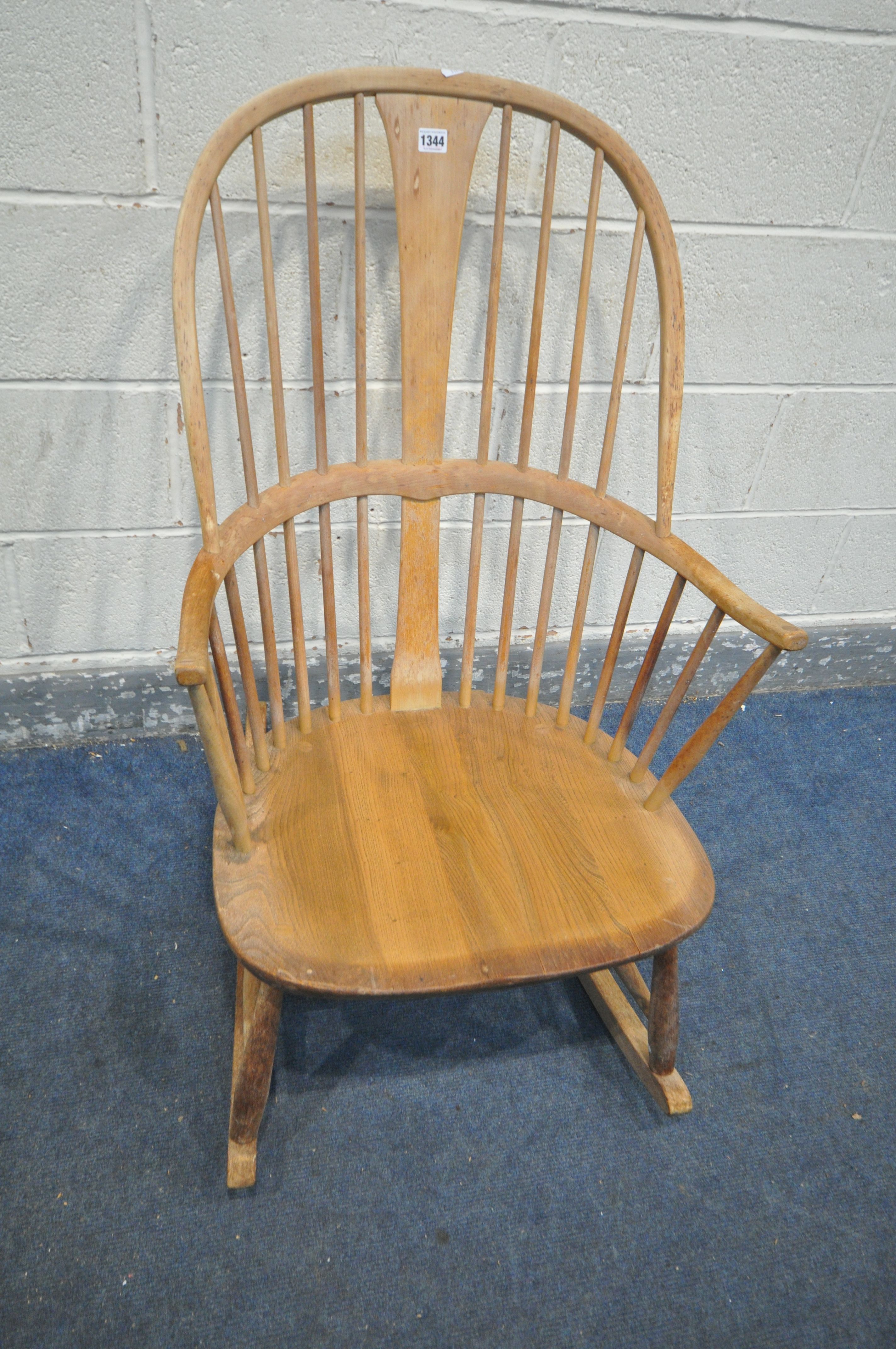 AN ERCOL ELM AND BEECH ROCKING CHAIR (condition - ideal for restoration due to discolouration, water