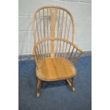 AN ERCOL ELM AND BEECH ROCKING CHAIR (condition - ideal for restoration due to discolouration, water