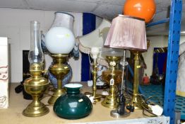EIGHT TABLE LAMPS, SHADES AND CHIMNEYS, comprising a brass based oil lamp, three electric lamps in