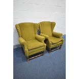 A PAIR OF EARLY 20TH CENTURY OAK WING BACK ARMCHAIRS, on a turned base united by a stretcher,