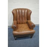 A BROWN LEATHER ARMCHAIR, with fluted back, on shaped front legs, width 89cm x depth 98cm x height