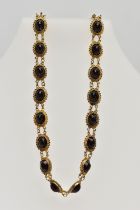 AN EARLY 20TH CENTURY RED PASTE SET CHOCKER NECKLACE, set with a series of oval cut red pastes, each