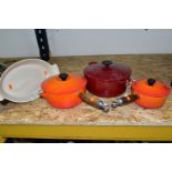 FOUR PIECES OF LE CREUSET CAST IRON ENAMELLED COOK WARES, comprising a dark red casserole dish,