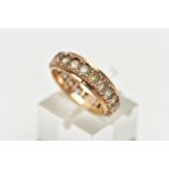 A YELLOW METAL FULL ETERNITY RING, set with a row of circular cut colourless stones assessed as