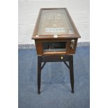 A VINTAGE TABLE TOP OAK CASED PINBALL MACHINE, labelled A REJOUER, with glass cover, on a later