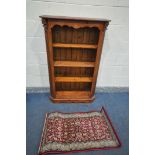 A PINE FOUR TIER OPEN BOOKCASE, width 88cm x depth 32cm x height 138cm, along with a small red