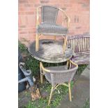 A HEAVY METAL FRAME CIRCULAR GARDEN TABLE with a mineral effect top 90cm in diameter along with a