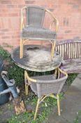 A HEAVY METAL FRAME CIRCULAR GARDEN TABLE with a mineral effect top 90cm in diameter along with a